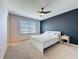Inviting bedroom features plush carpets, a ceiling fan and accent wall creating a cozy retreat at 1510 Chelsea Dr, Davenport, FL 33897