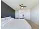 Spacious main bedroom with a neutral carpet, ceiling fan, and freshly painted accent wall at 1510 Chelsea Dr, Davenport, FL 33897