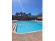 Inviting community pool features clear blue water, palm trees, lounge chairs, and nearby building access at 1510 Chelsea Dr, Davenport, FL 33897