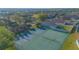 Discover the aerial view showcasing the community's tennis and pickleball courts amidst lush landscaping at 153 Cambridge Ave, Davenport, FL 33896