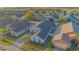 Aerial view showcases this neighborhood home with manicured lawn and brick driveway, in a desirable community at 153 Cambridge Ave, Davenport, FL 33896