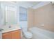 Cozy bathroom featuring a shower-tub combo, window, and a single-sink vanity at 153 Cambridge Ave, Davenport, FL 33896