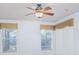 Bedroom with two windows, ceiling fan, and neutral window treatments at 153 Cambridge Ave, Davenport, FL 33896