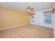 Bedroom with neutral carpet, ceiling fan, and two windows offering natural light at 153 Cambridge Ave, Davenport, FL 33896