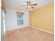 Bedroom with neutral carpet, ceiling fan, and a window overlooking the pool area at 153 Cambridge Ave, Davenport, FL 33896