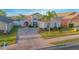 Charming single-Gathering home with a brick driveway, well-maintained landscaping, and a two-car garage at 153 Cambridge Ave, Davenport, FL 33896