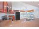 Bright kitchen featuring dark appliances, wooden cabinets, granite countertops, tile flooring, and a breakfast nook at 153 Cambridge Ave, Davenport, FL 33896