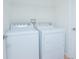 Well-lit laundry room with a modern washer and dryer set at 153 Cambridge Ave, Davenport, FL 33896