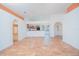 Spacious living room featuring tile flooring, high ceilings, arches, and an open floor plan into the kitchen at 153 Cambridge Ave, Davenport, FL 33896