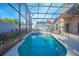 Enjoy this screened-in pool with lush landscaping, patio, and dining set, perfect for outdoor relaxation and entertaining at 153 Cambridge Ave, Davenport, FL 33896