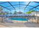 Fully screened pool with a safety fence at 153 Cambridge Ave, Davenport, FL 33896