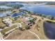 An aerial view of the community clubhouse, pools, and landscaping with lake views in the background at 16694 Olive Hill Dr, Winter Garden, FL 34787