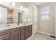 Bathroom with a double sink vanity with dark wood cabinets, tile floors, and walk in shower at 16694 Olive Hill Dr, Winter Garden, FL 34787