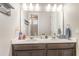 Well-lit bathroom featuring a double sink vanity and modern fixtures at 16694 Olive Hill Dr, Winter Garden, FL 34787