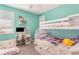 Inviting bedroom featuring a bunk bed, desk area, and a bright, cheerful atmosphere at 16694 Olive Hill Dr, Winter Garden, FL 34787