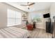 Bedroom featuring wood floors, a ceiling fan, and a desk with a computer at 16694 Olive Hill Dr, Winter Garden, FL 34787