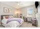 Well-lit bedroom with a dedicated workspace, plush bed, and tasteful decor at 16694 Olive Hill Dr, Winter Garden, FL 34787