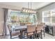 Bright dining room with modern lighting, backyard and pool access through sliding glass doors at 16694 Olive Hill Dr, Winter Garden, FL 34787