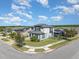 Daytime exterior elevation view of a two-story home with a screened-in pool and landscaping at 16694 Olive Hill Dr, Winter Garden, FL 34787