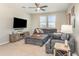 Cozy living room with comfortable seating, a large television, and carpeted floors at 16694 Olive Hill Dr, Winter Garden, FL 34787