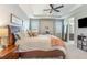 Bright main bedroom with trey ceilings, fan, carpeted floors and ensuite bathroom access at 16694 Olive Hill Dr, Winter Garden, FL 34787