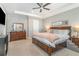 Spacious main bedroom with wood furniture, a ceiling fan and carpeted floors at 16694 Olive Hill Dr, Winter Garden, FL 34787