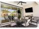 Inviting outdoor dining area with a table and chairs, a television, and views of the pool at 16694 Olive Hill Dr, Winter Garden, FL 34787
