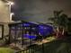 Backyard view of a screened-in pool and patio area with outdoor seating and landscape lighting at 16694 Olive Hill Dr, Winter Garden, FL 34787