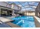 Inviting screened-in pool with a fountain feature and lounge chairs at 16694 Olive Hill Dr, Winter Garden, FL 34787