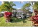 Beautifully landscaped backyard featuring a screened-in pool area and lush tropical foliage at 16694 Olive Hill Dr, Winter Garden, FL 34787