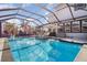 Inviting screened-in pool with a fountain feature and lounge chairs at 16694 Olive Hill Dr, Winter Garden, FL 34787