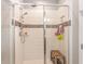 Shower featuring tiled walls with decorative pattern and a small wooden bench at 16694 Olive Hill Dr, Winter Garden, FL 34787