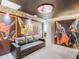 Themed basement featuring custom wall art, a comfortable sofa, and unique design elements, perfect for entertainment or relaxation at 1800 Tropical Palms Cir, Kissimmee, FL 34747