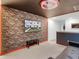 Themed basement featuring custom wall art, a comfortable sofa, and unique design elements, perfect for entertainment or relaxation at 1800 Tropical Palms Cir, Kissimmee, FL 34747