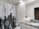 Themed bathroom with superhero shower curtain, granite counter, and decorative towels at 1800 Tropical Palms Cir, Kissimmee, FL 34747