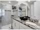 Bright bathroom featuring double sinks, granite countertop, and glass-enclosed shower at 1800 Tropical Palms Cir, Kissimmee, FL 34747