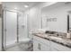 Clean bathroom featuring a glass-enclosed shower, white vanity, and granite countertop at 1800 Tropical Palms Cir, Kissimmee, FL 34747