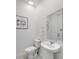 Compact powder room with pedestal sink, toilet, and framed 'forever grateful' print at 1800 Tropical Palms Cir, Kissimmee, FL 34747