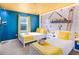 Bright bedroom featuring a Minions themed accent wall and comfortable beds at 1800 Tropical Palms Cir, Kissimmee, FL 34747