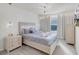 Comfortable bedroom featuring a plush gray bed, dresser, and modern lighting at 1800 Tropical Palms Cir, Kissimmee, FL 34747