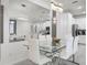 Bright dining room featuring white chairs and a glass table with modern lighting, and a mirrored wall for added aesthetic at 1800 Tropical Palms Cir, Kissimmee, FL 34747