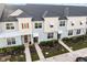 Charming townhomes feature neutral-toned exteriors, well-manicured landscaping, and inviting entryways at 1800 Tropical Palms Cir, Kissimmee, FL 34747