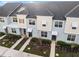 Stylish townhomes featuring neutral-toned exteriors, manicured lawns, and inviting front entrances at 1800 Tropical Palms Cir, Kissimmee, FL 34747