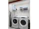 Convenient laundry room with a modern washer and dryer, plus shelving at 1800 Tropical Palms Cir, Kissimmee, FL 34747