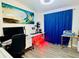 Charming office space with bright work area, unique wall art, and stylish blue curtains at 18304 Cedarhurst Rd, Orlando, FL 32820