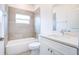 Updated bathroom with bathtub, shower, large window and vanity with quartz countertop at 2033 10Th Ave, Deland, FL 32724