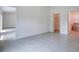 Open Primary bedroom with tile flooring, ensuite bathroom, and walk-in closet at 2033 10Th Ave, Deland, FL 32724