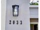 A close-up on the address number 2033 on the side of a house at 2033 10Th Ave, Deland, FL 32724