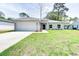 Charming single-story home with a well-manicured lawn and attached two-car garage at 2033 10Th Ave, Deland, FL 32724