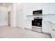 Modern kitchen with white cabinets, stainless steel appliances, and tile floors at 2033 10Th Ave, Deland, FL 32724